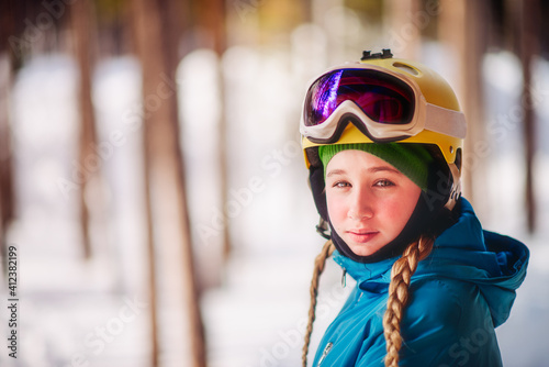 Girl stands outside wearing ski gear and a teenager expression of exasperation