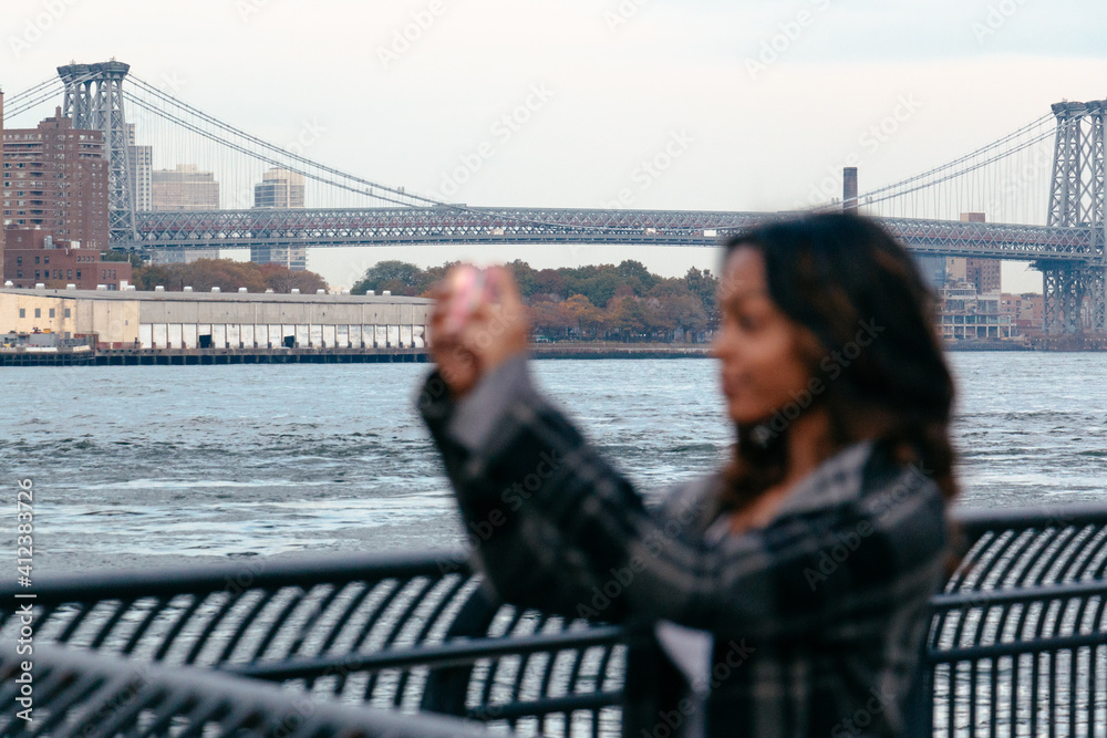 Woman taking photos with mobile phone in New York Woman taking photos with mobile phone in New York