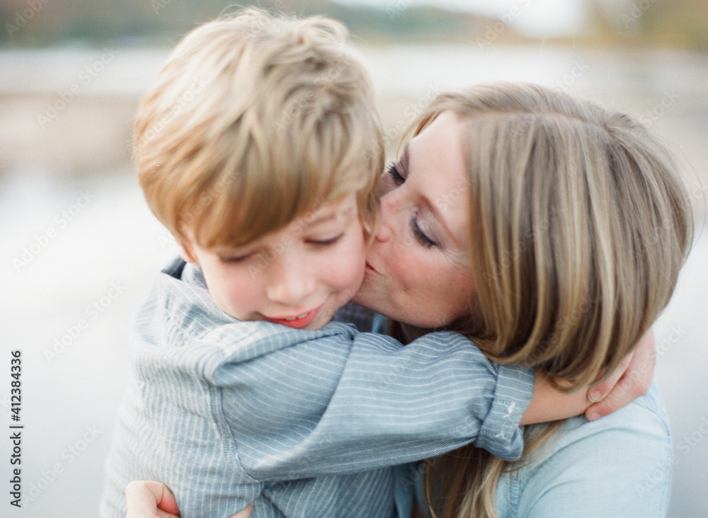 Mother and son sitting together and hugging Mother and son sitting together and hugging