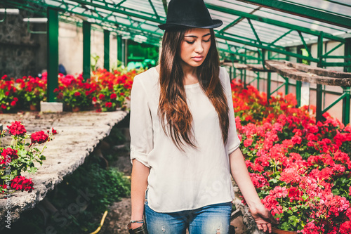 Young Asian Woman in an Old Greenhouse