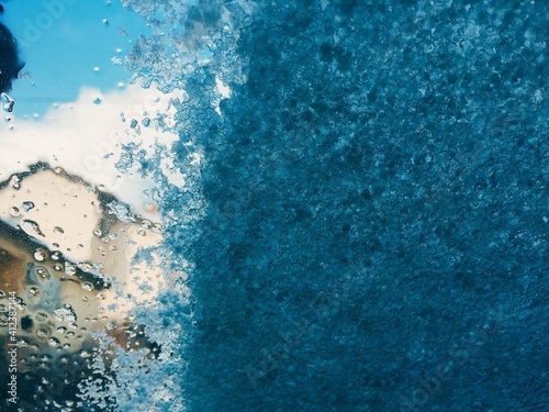 Blue ice background on the car windshield