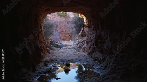 Tunnel carved in sandstone in the Utah desert for water to move under the road in Zion National Park. photo