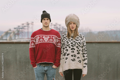 Beautiful hipster couple standing on the roof photo