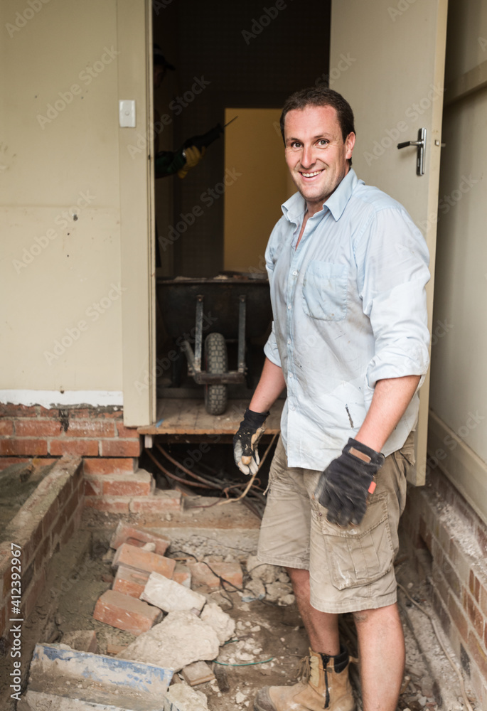 man in the midst of a demolished room
