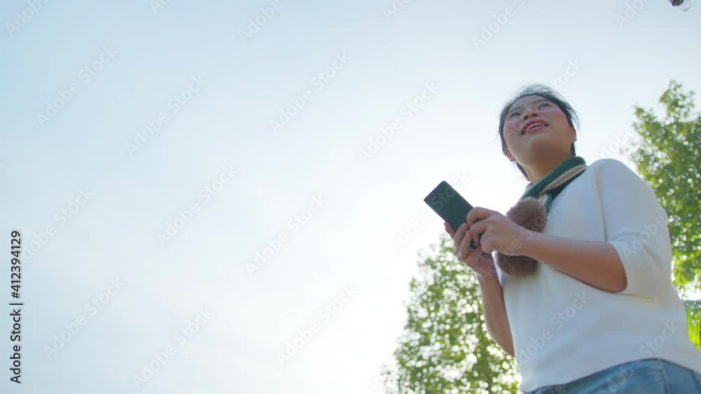 happiness asian female woman hand use smartphone to texting tell travel story to her friend with freshness and cheerful with background of mountian forest nature park morning moment happiness asian female woman hand use smartphone to texting tell travel story to her friend with freshness and cheerful with background of mountian forest nature park morning moment