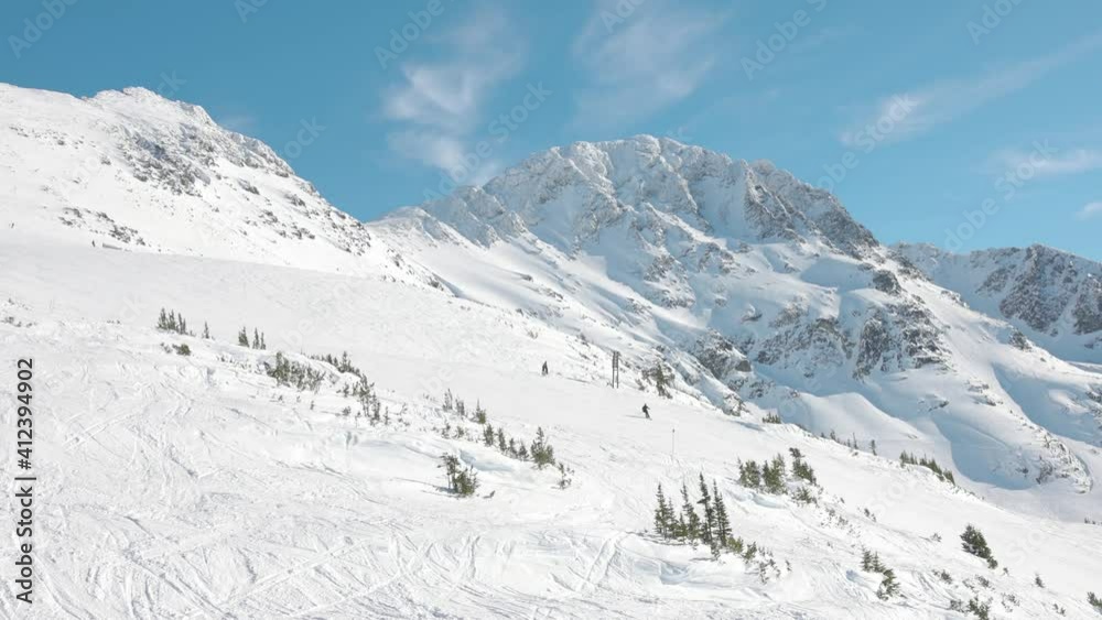 Snowy Forest on top of the mountains in winter during sunny morning. Beautiful White Canadian Nature. Taken in Whistler, British Columbia, Canada. Aerial View Slow Motion Snowy Forest on top of the mountains in winter during sunny morning. Beautiful White Canadian Nature. Taken in Whistler, British Columbia, Canada. Aerial View Slow Motion