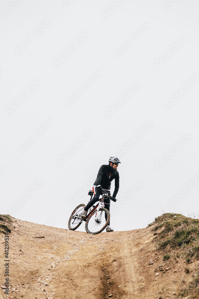 Mountain Bike Rider Prepared to Down a Hill Mountain Bike Rider Prepared to Down a Hill