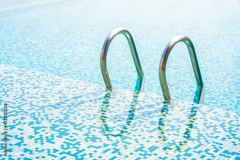 Umbrella and chair around outdoor swimming pool in hotel resort Umbrella and chair around outdoor swimming pool in hotel resort