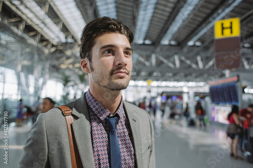 Wallpaper Mural Young entrepreneur waiting at the airport alone Torontodigital.ca