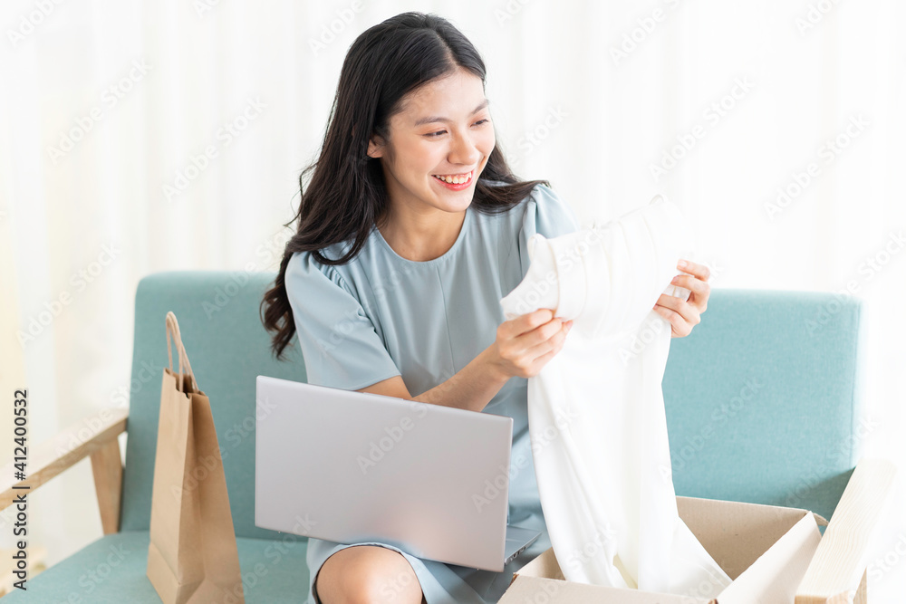 Young asian girl sitting at home selling online Young asian girl sitting at home selling online