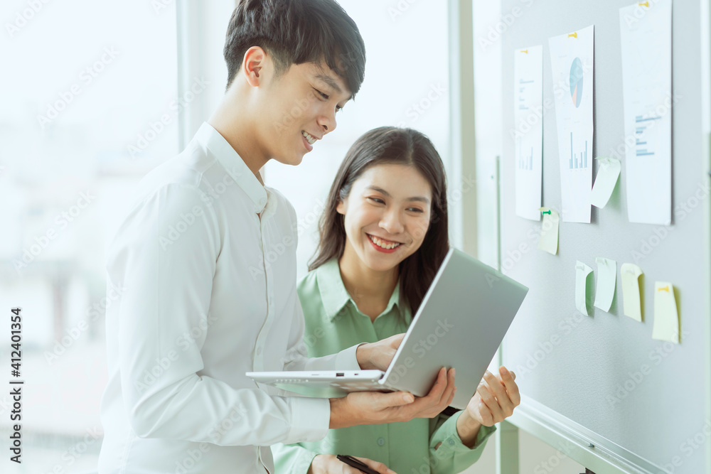Young Asian business couple working together, completing the assigned work Young Asian business couple working together, completing the assigned work