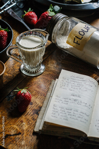 Ingredients for baking on table with recipe book at an open page.