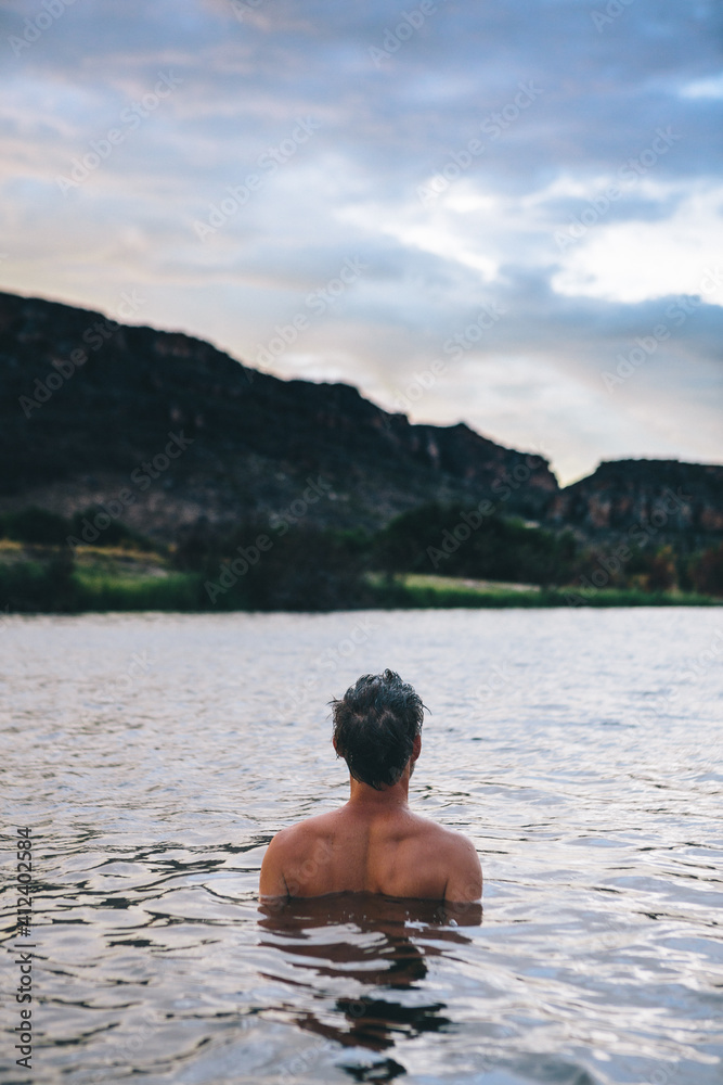 man swimming in a lake