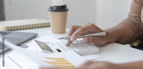Tablou pe pânză Financial businessman calculating corporate income tax data And analyzing charts of financial stocks that are in good condition with growth and progress, Investment in finance and accounting