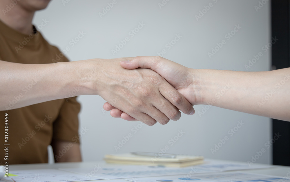 Financial accountants and marketers shaking hand to congratulate the double-digit real estate performance, Meetings or hand shake concept.