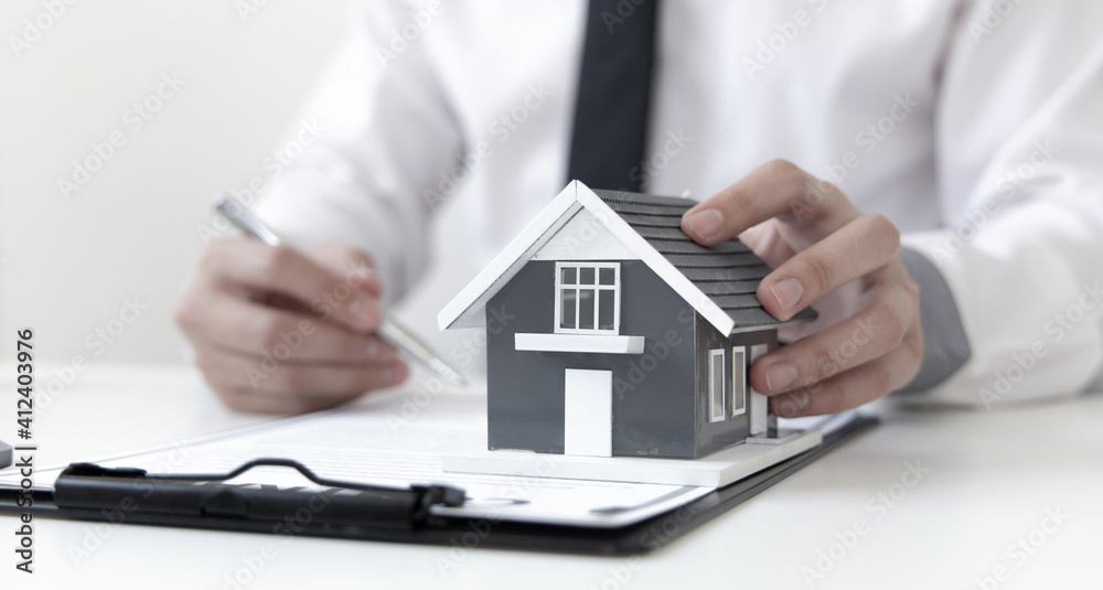 Sales manager or real estate agent will be prepared to show you a sample home and detail the terms of buying a home with insurance promotions, Attention to property services and insurance concept. Sales manager or real estate agent will be prepared to show you a sample home and detail the terms of buying a home with insurance promotions, Attention to property services and insurance concept.