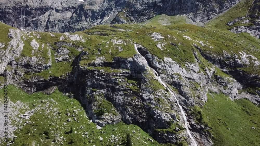 High-altitude mountainous terrain covered with green grass in the middle of the most beautiful valley. Small stream of a mountain river High-altitude mountainous terrain covered with green grass in the middle of the most beautiful valley. Small stream of a mountain river