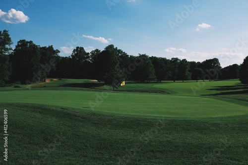 Golf course green and fairway in the late summer afternoon