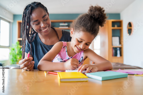 A father helping her daughter with homeschool. photo