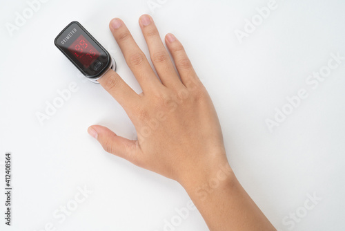 Top view of Pulse Oximeter, finger digital device to measure person's oxygen saturation. Reduced oxygenation is an emergency sign of pneumonia caused by flu or novel coronavirus. Device on Fingertip