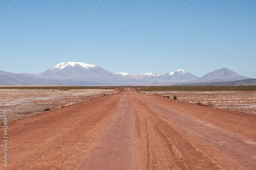 Old dirt track with mountains in the distance. Old dirt track with mountains in the distance.