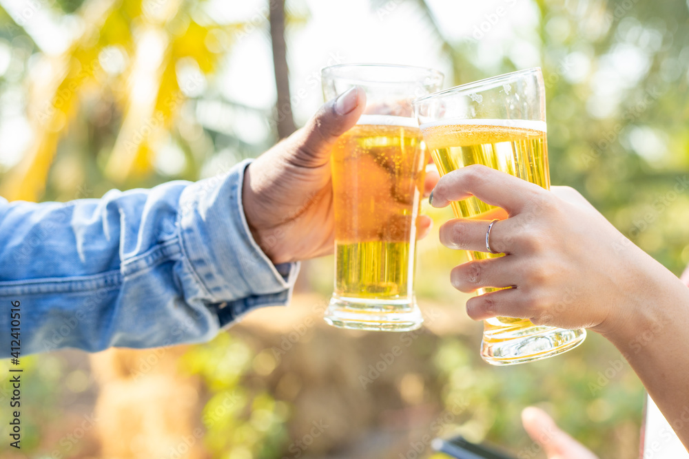 Two friends were happy toasting glasses and drinking beer on vacation. Two friends were happy toasting glasses and drinking beer on vacation.