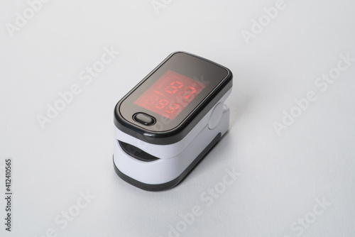 Portable digital fingertip oximeter isolated on white background