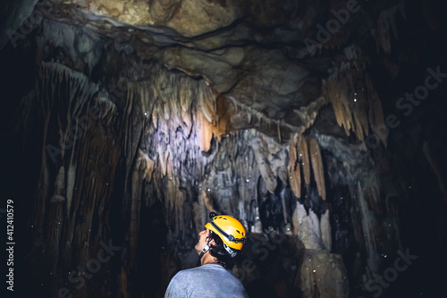 Wallpaper Mural Man Wearing Headlamp and Helmet Wonders at Beautiful Cave Formations Torontodigital.ca