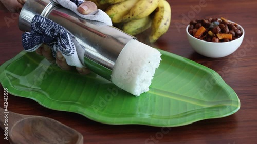 Rice Puttu white Pittu , Kadala Chickpea curry , milk tea , popular South Indian breakfast steamed rice cake 4K slow motion video footage Kerala Tamil Nadu India Sri Lanka. rice flour grated coconut   photo