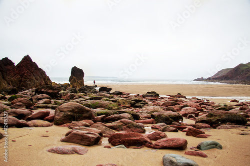 Red sandstone rocks on a beach photo