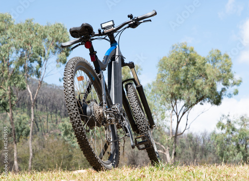 Rear view of Electric mountain bike in beautiful rural australia gum trees and blue sky
