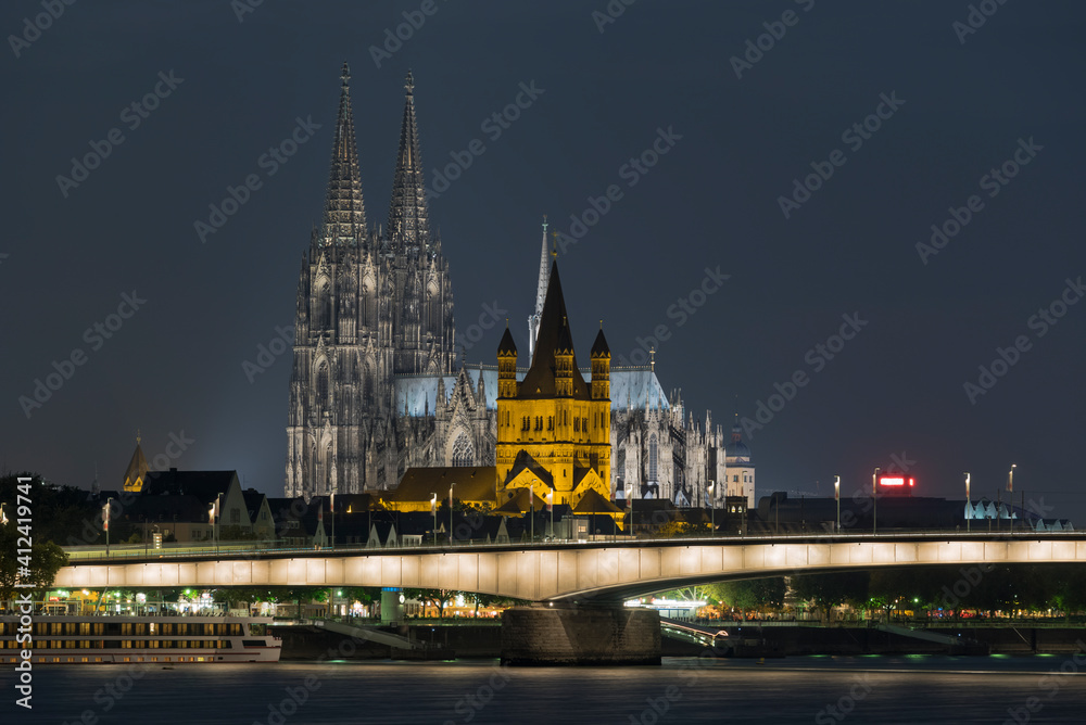 Cologne (KÔøΩ_ln), Germany - City Skyline with the Cathedral and Great St. Martin Church at Night Cologne (KÔøΩ_ln), Germany - City Skyline with the Cathedral and Great St. Martin Church at Night