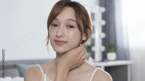 closeup smiling young korean lady looking at herself in the mirror hand feel her flawless skin softly after putting on day cream. anti-aging beauty routine concept. Free Download closeup smiling young korean lady looking at herself in the mirror hand feel her flawless skin softly after putting on day cream. anti-aging beauty routine concept. - GFXLoad