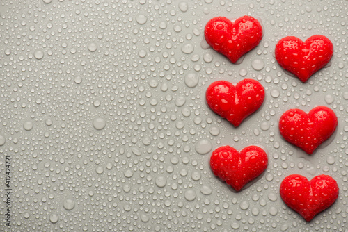 Overhead top above close up view photo of valentine day red hearts on grey backdrop with drops