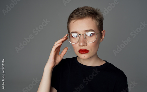 Pretty woman with short hair in glasses red lips attractive view close-up