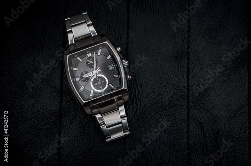 Metal wrist watch on black background. Stock Photo