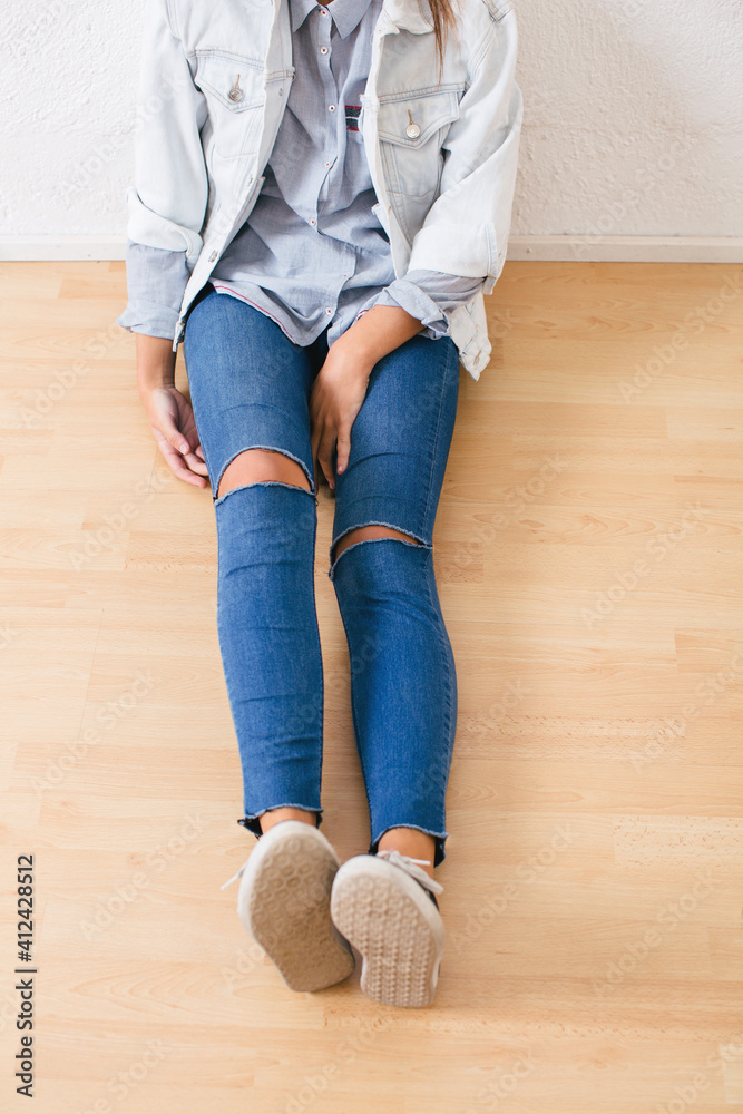 Closeup of an anonymous woman wearing casual denim clothes. Closeup of an anonymous woman wearing casual denim clothes.