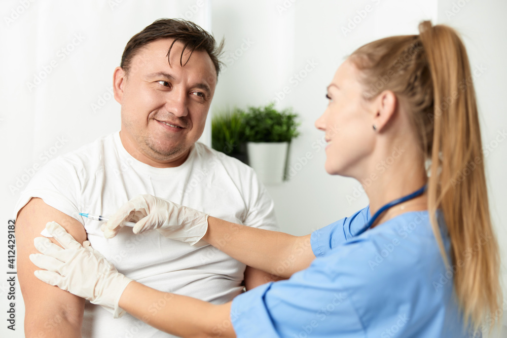male patient in hospital next to doctor injection vaccination male patient in hospital next to doctor injection vaccination