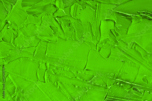 Green abstract texture of surface covered with putty. Grain and noise effect.  Wall background covered with putty photo
