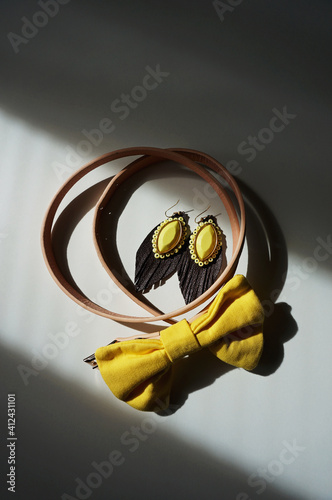 Yellow fashion details captured on white desk