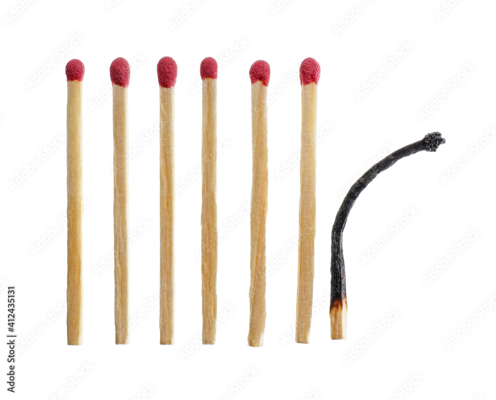 One burnt out match among whole ones on white background One burnt out match among whole ones on white background