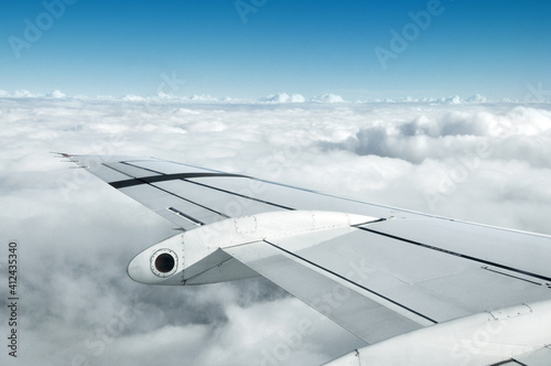 airplane wing flying through the clouds photo