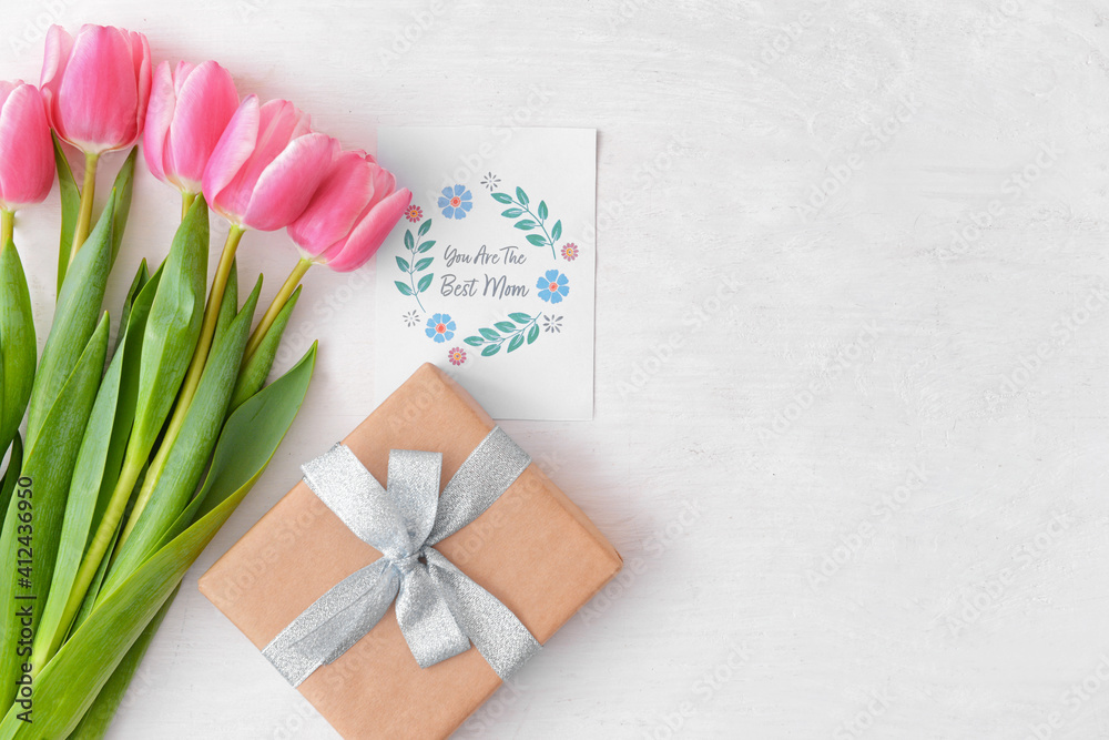 Beautiful flowers, gift and greeting card for Mother's Day on white background Beautiful flowers, gift and greeting card for Mother's Day on white background