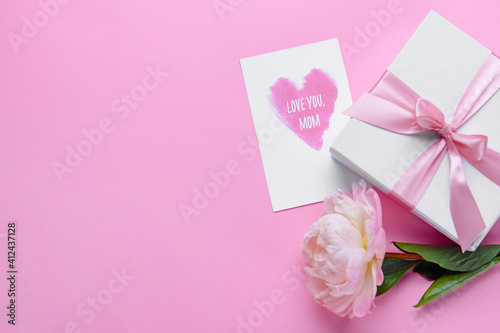 Beautiful flower, gift and greeting card for Mother's Day on color background