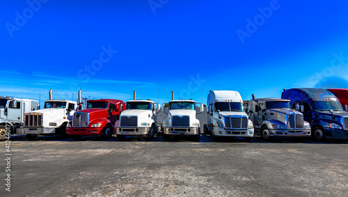 HDR image of Semi trucks lined up on a parking lot.