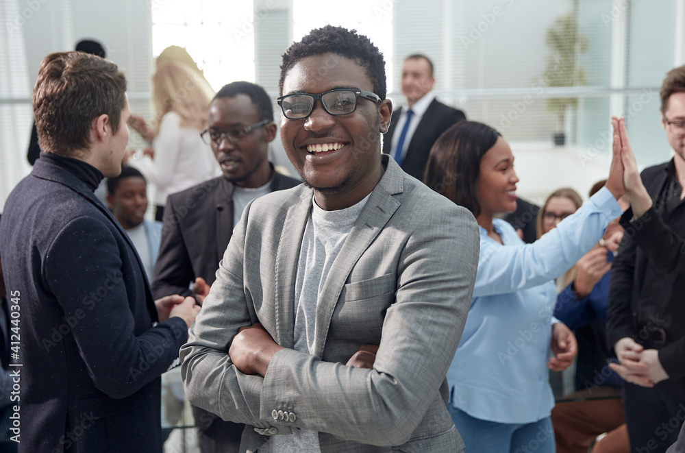 smiling young business man standing among his colleagues. smiling young business man standing among his colleagues.