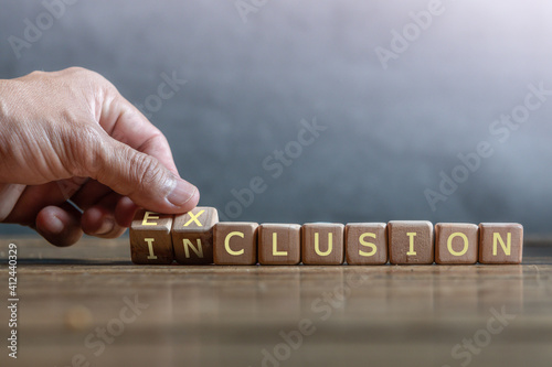 Tableau sur toile hand holding dice with text for illustration of EXLUCSION and INCLUSION words