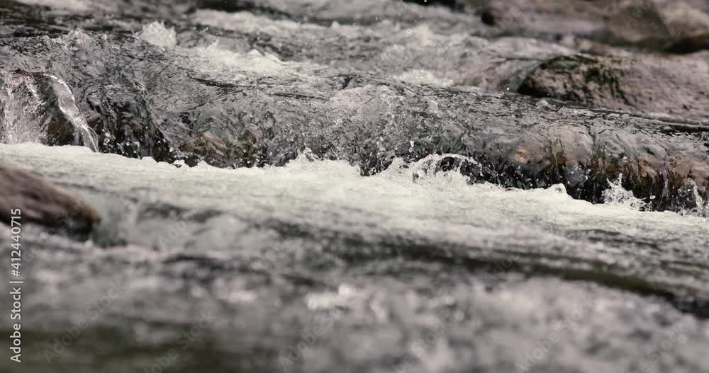 Details with the clear water of a running mountain stream during a cold and sunny winter day in the Romanian Carpathian Mountains. Details with the clear water of a running mountain stream during a cold and sunny winter day in the Romanian Carpathian Mountains.