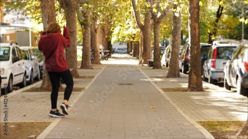 Wallpaper Mural I dance alone - carefree young girl dances alone on the street Torontodigital.ca