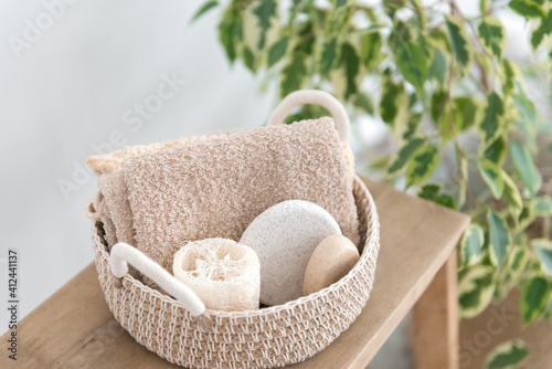 jute basket with body care products - organic soap, sponge, loofah and towel